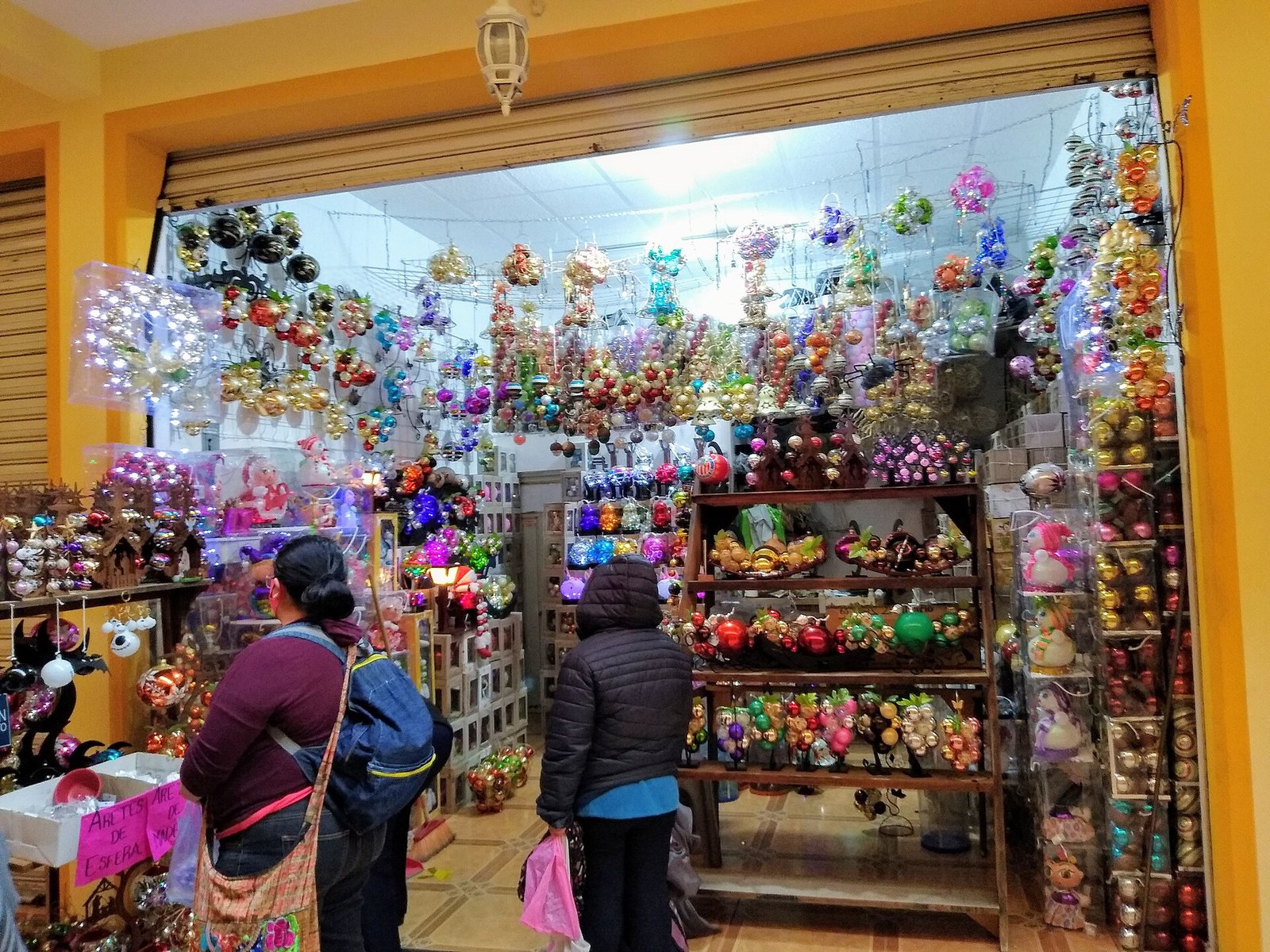 Local de venta de esferas navideñas de colores colgadas del techo y en estantes, en Chignahuapan, Puebla